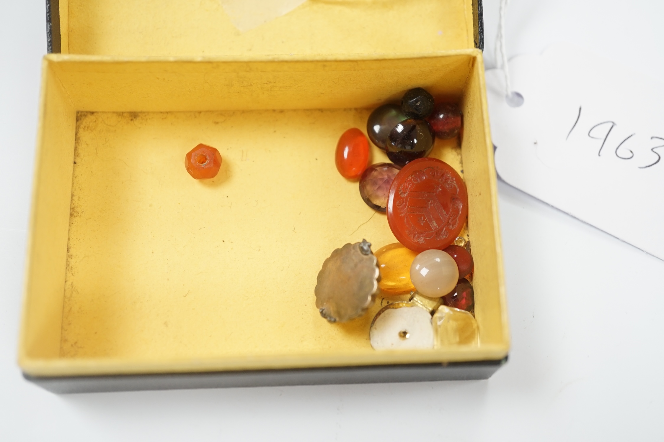 A small quantity of loose cut and cabochon gemstones including carnelian, white opal etc.